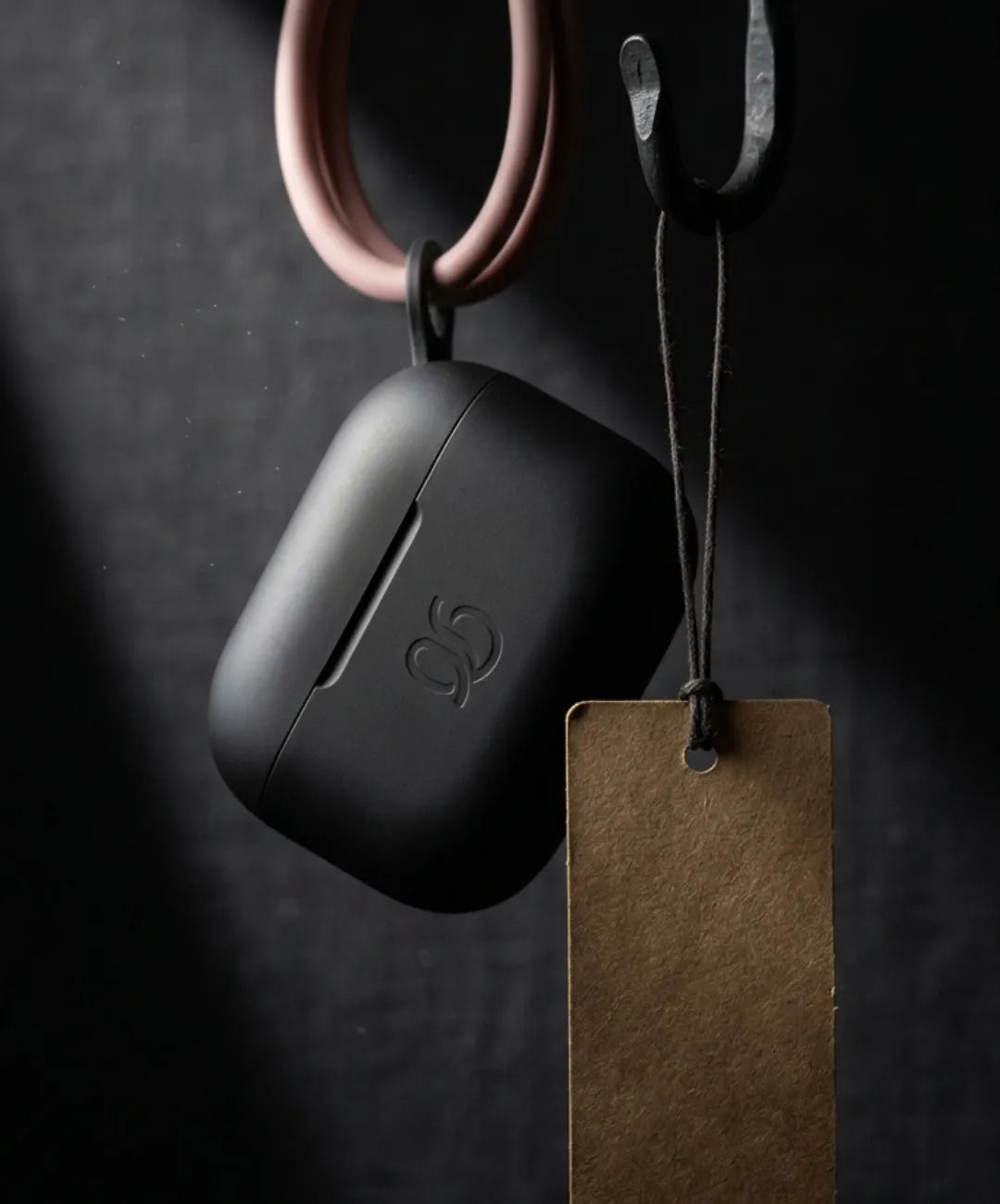 Vertical product photography of a fitness accessory with a blank hanging price tag, dark contrasting background, dramatic spotlight lighting, sense of a special promotion, no text, no people, 9:16 aspect ratio, commercial style